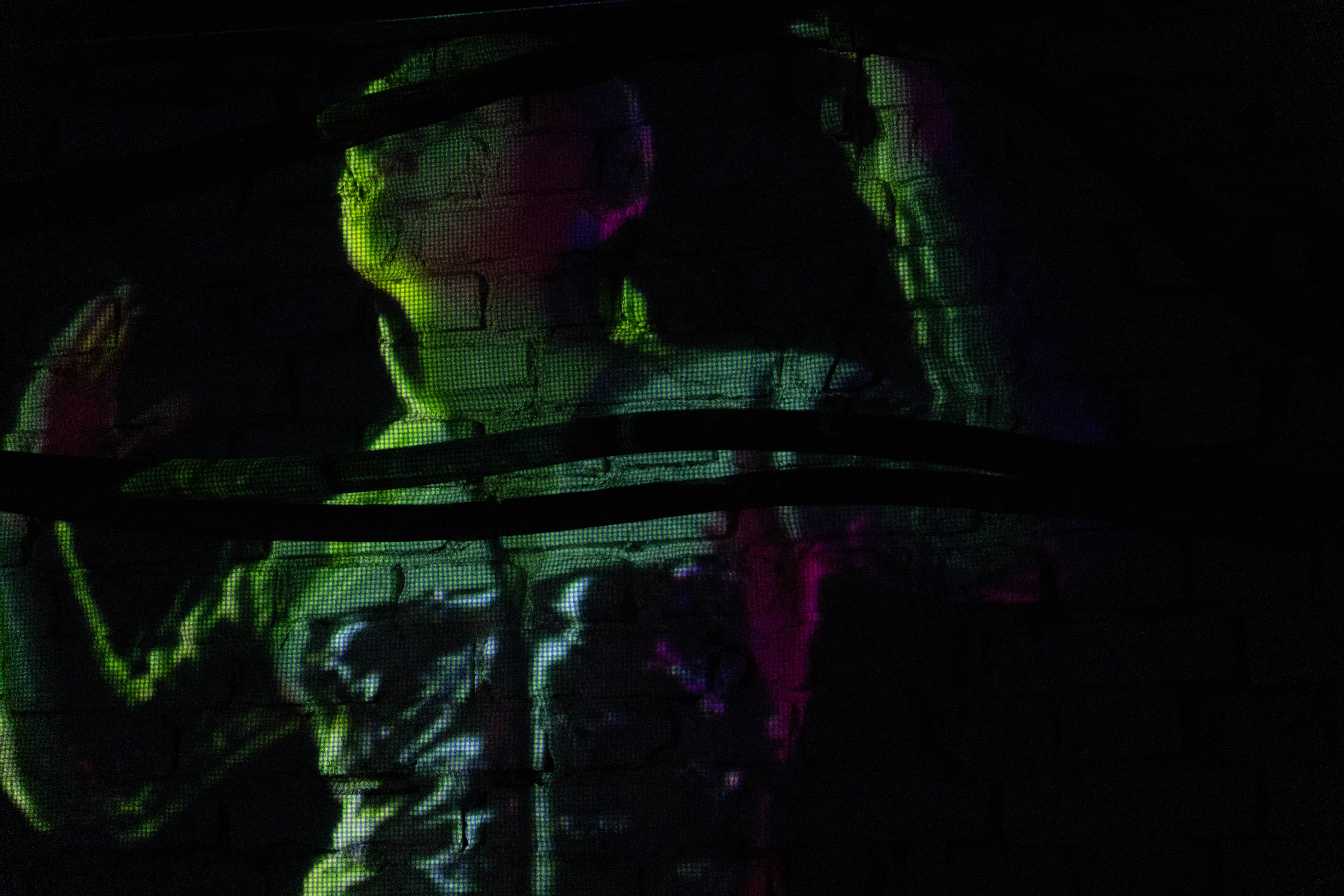 Charter X projected in a dark gallery space, evoking deep space immersion and speculative futurism