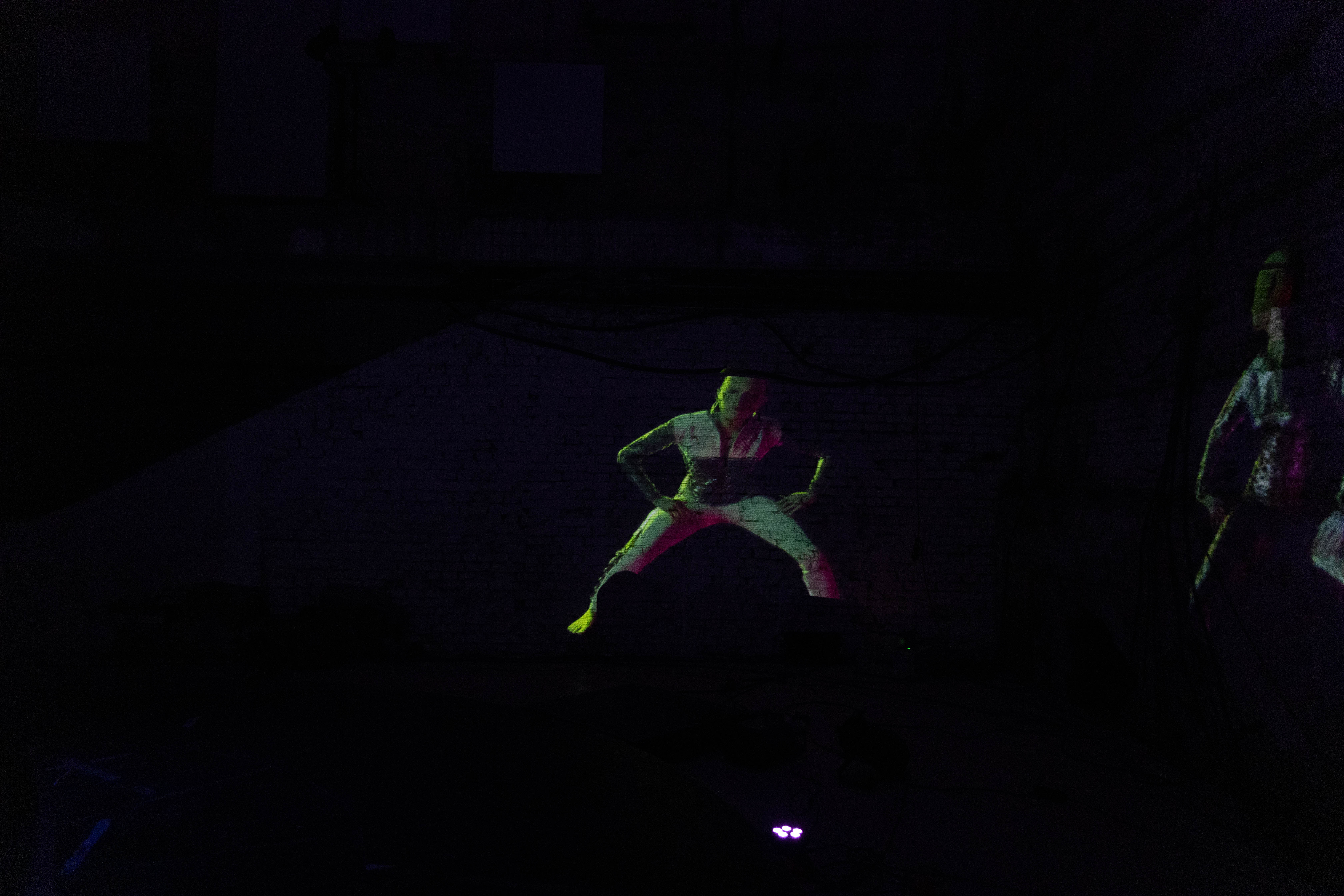 Charter X projected in a dark gallery space, evoking deep space immersion and speculative futurism