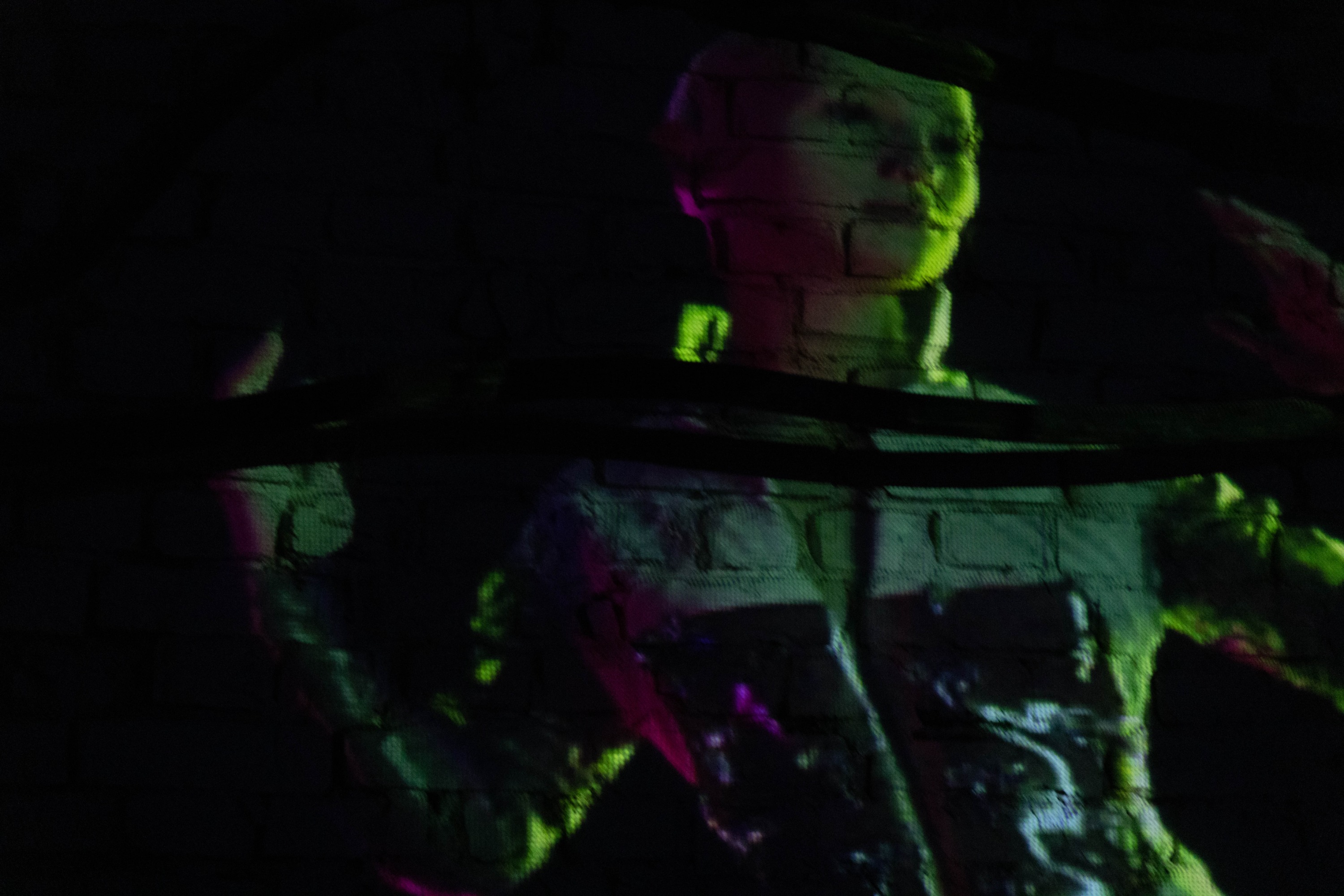 Charter X projected in a dark gallery space, evoking deep space immersion and speculative futurism